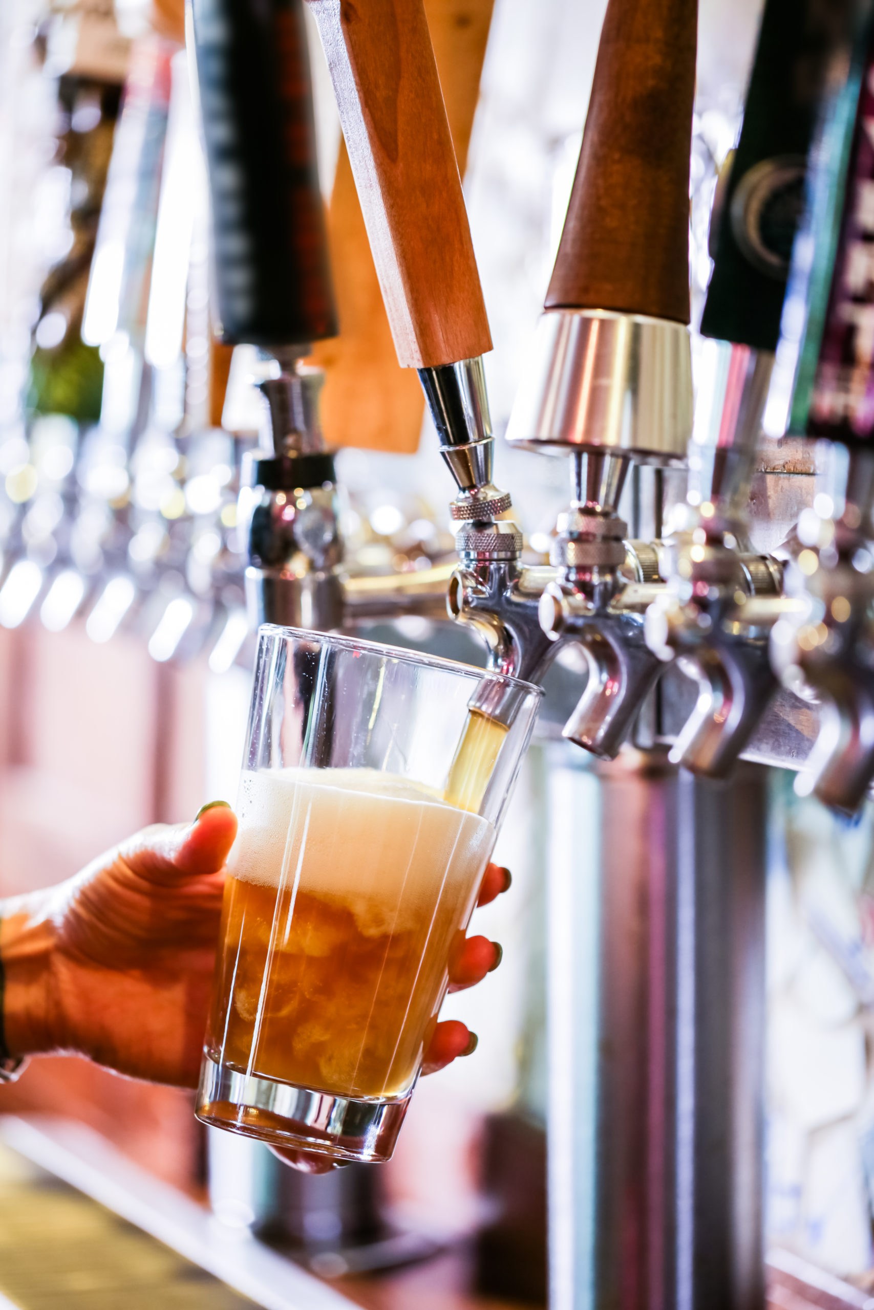 Bartender pouring draft beer in the bar.